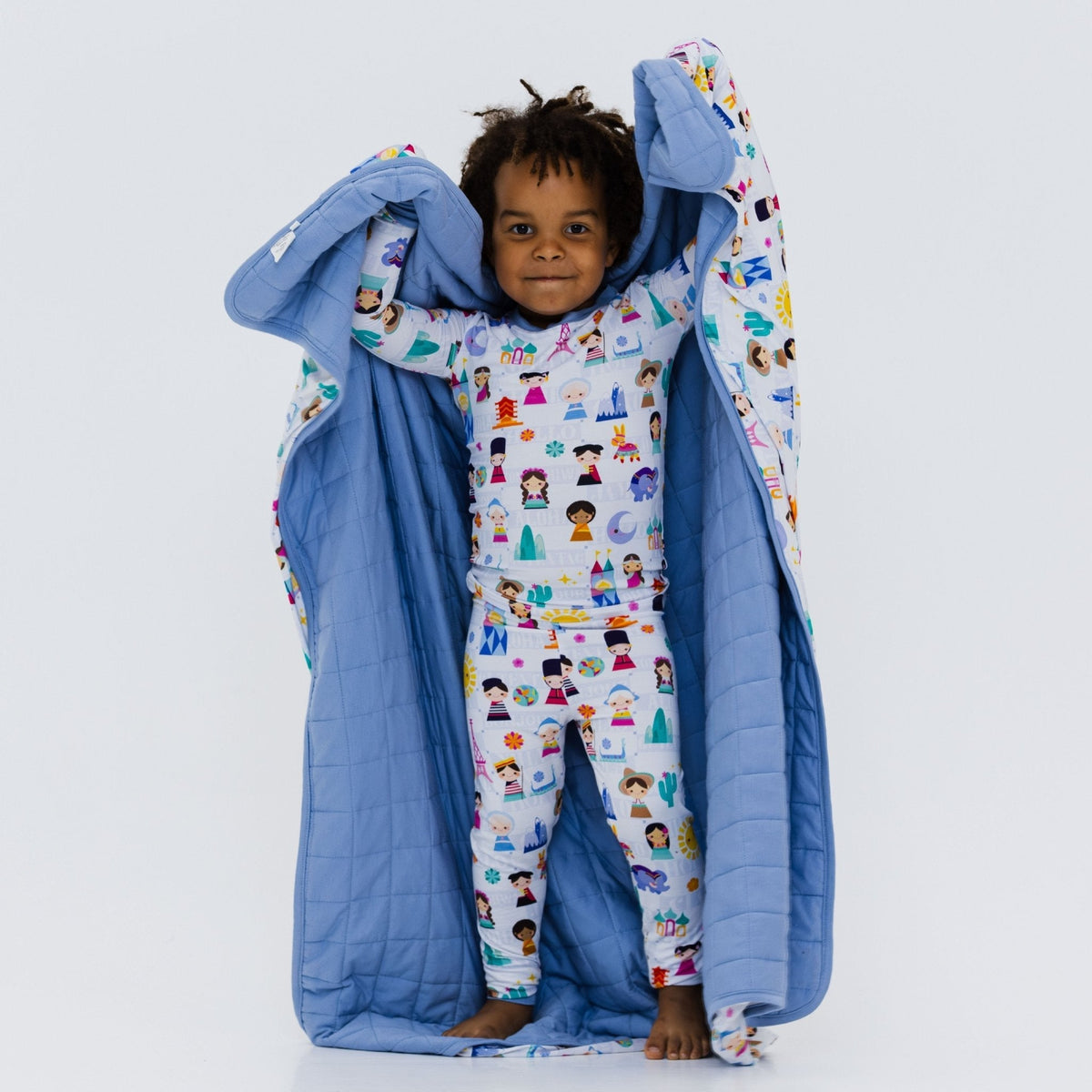 Child holding Bam & Stitch Children of the World Blanket open to show both sides.