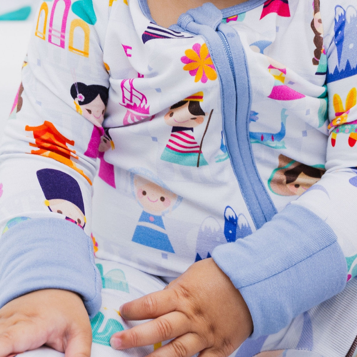 Close-up of the front zipper and fabric on Bam & Stitch Children of the World Convertible Romper.