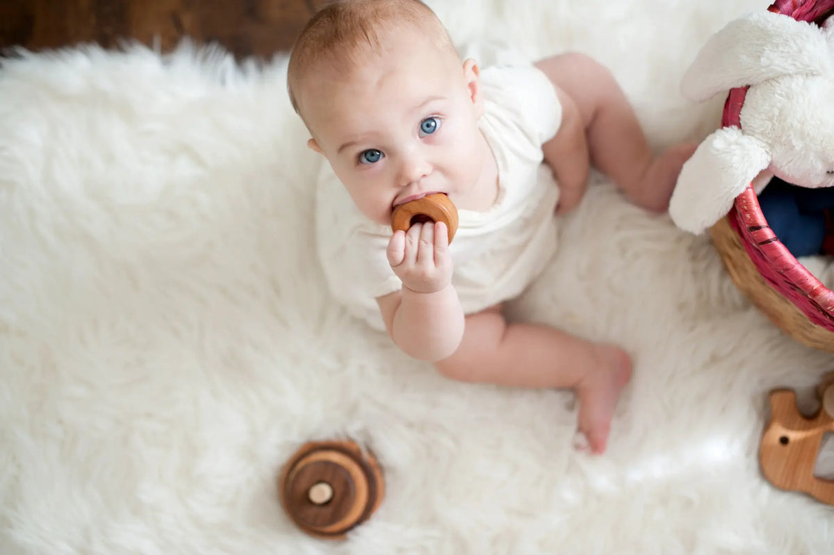 Lifestyle photo showing wooden stacking rings with a child