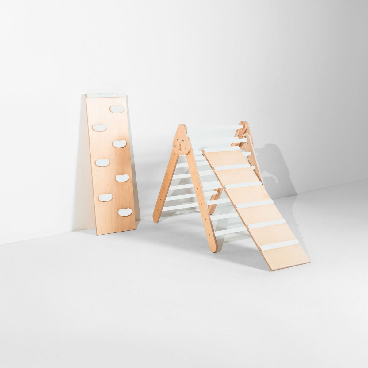 White-rung triangle with attached ladder ramp and a white-hold climbing ramp beside it.