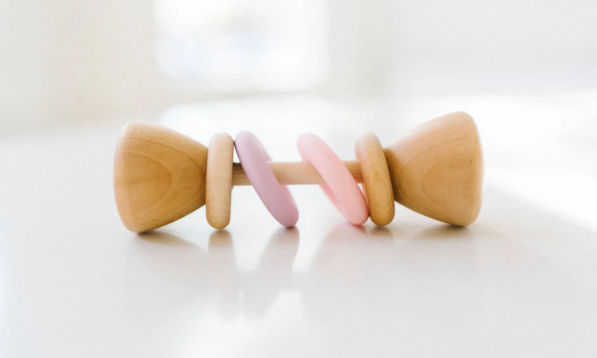 Bannor Toys Color Block Classic Baby Rattle, showing wooden body and colored silicone rings
