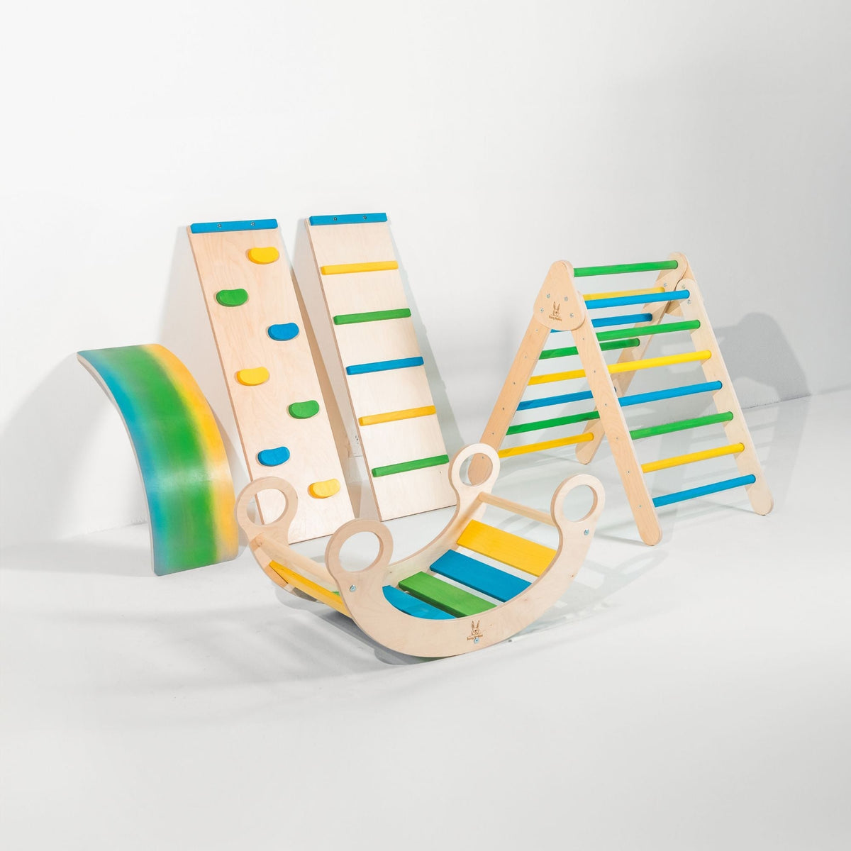 Blue, green and yellow triangle, two ramps, curved wobble board and rocker displayed together.