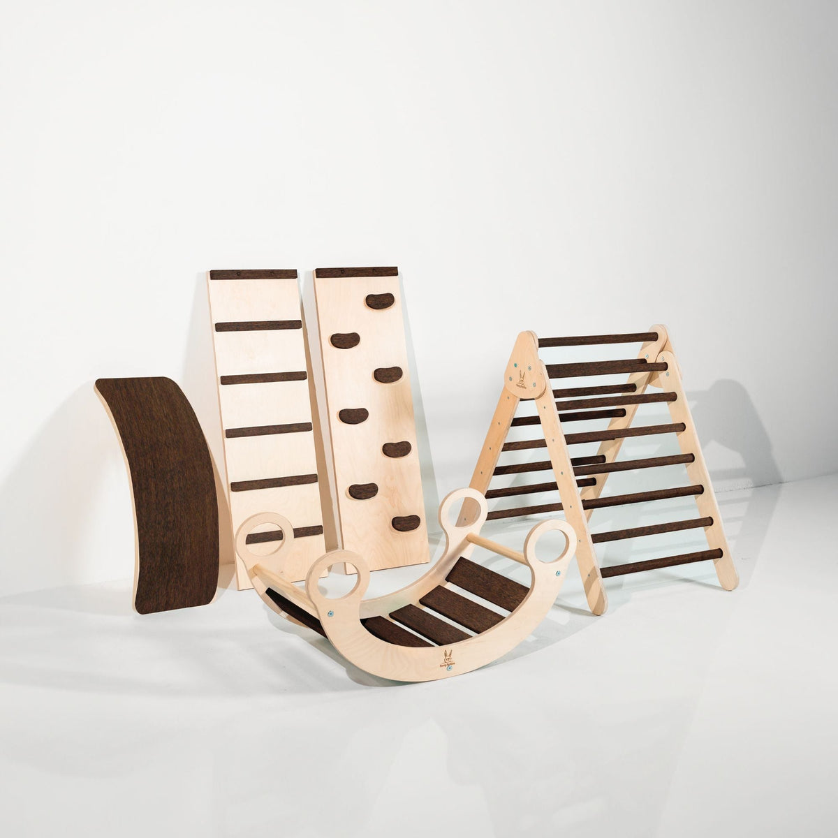 Dark-brown-accent triangle, two ramps, curved wobble board and rocker displayed together.