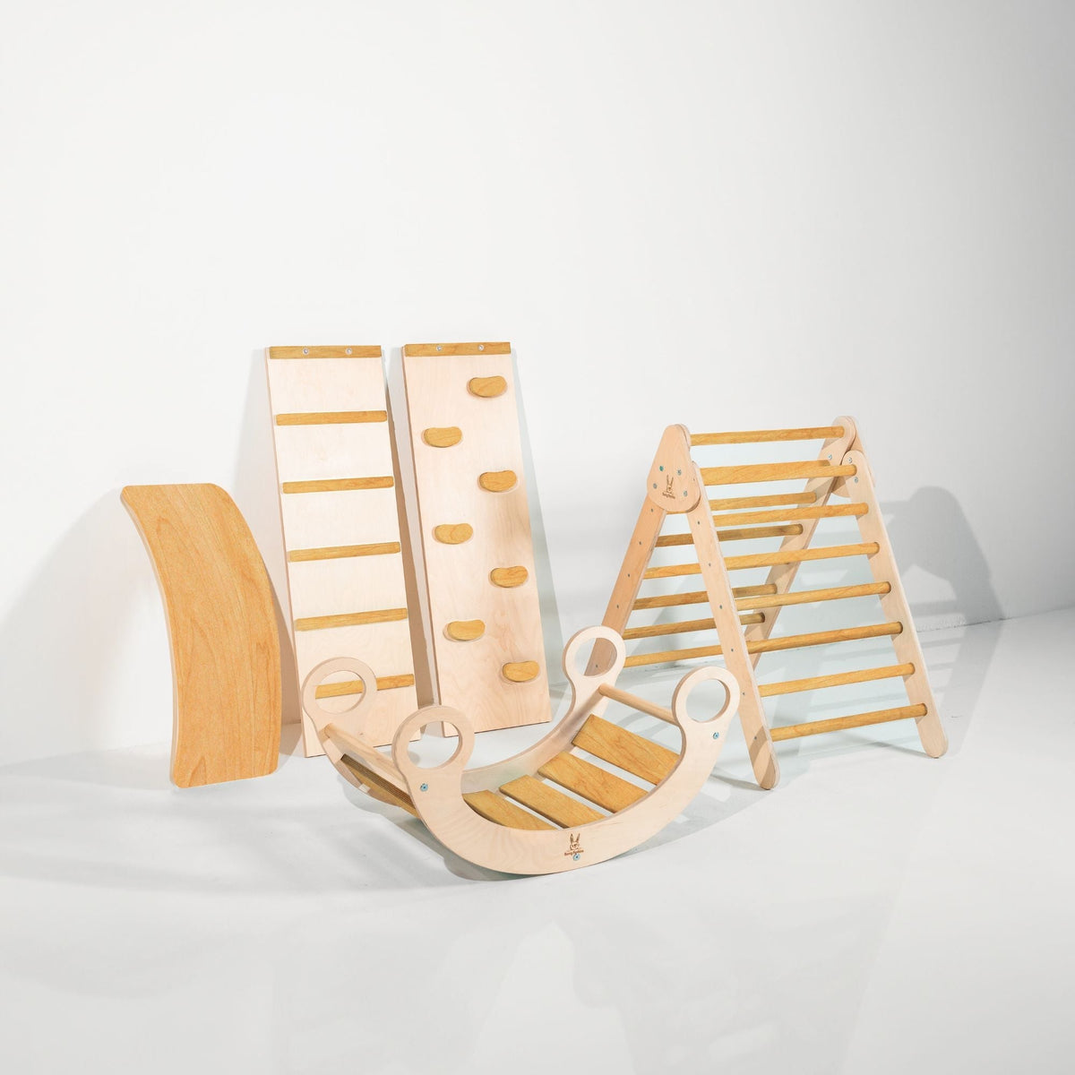 Golden-tan-accent triangle, two ramps, curved wobble board and rocker displayed together.