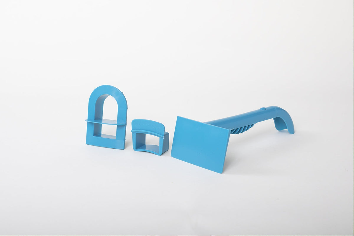Blue Tool Kit with an arched window cutter, rectangular battlement form and two-ended sculpting tool on white.