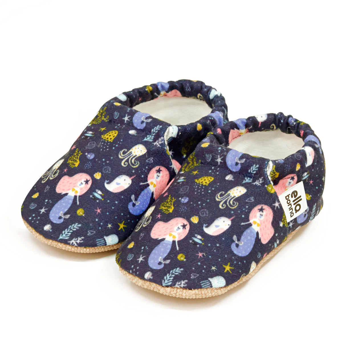 Pair of navy slip-on baby moccasins with mermaids and sea-creature print on a white background.