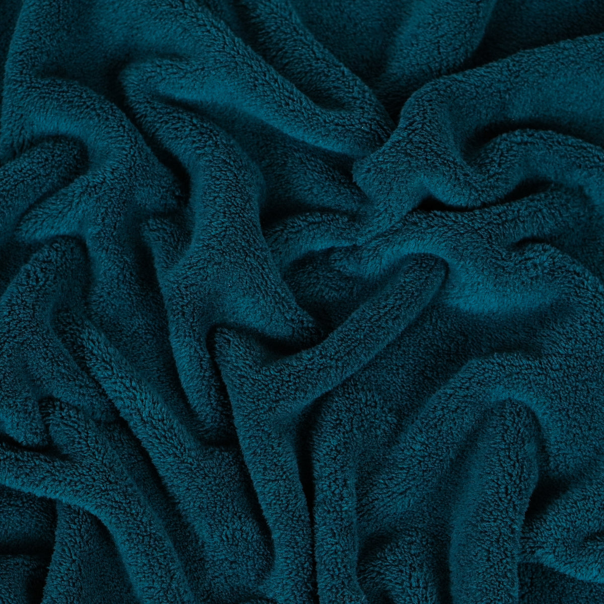 Teal fleece blanket gathered to show texture.