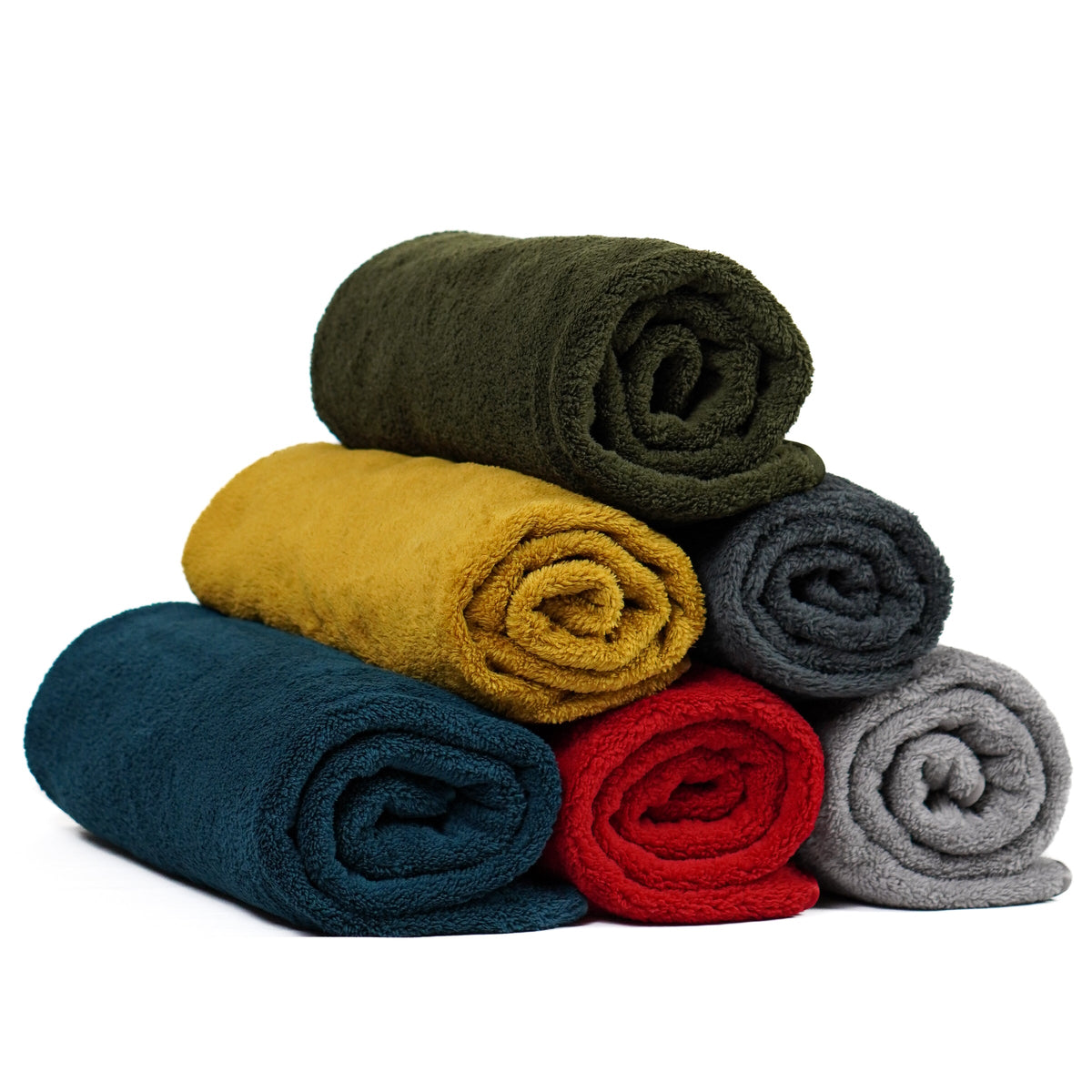 Six rolled fleece blankets in assorted colors stacked in a pyramid.
