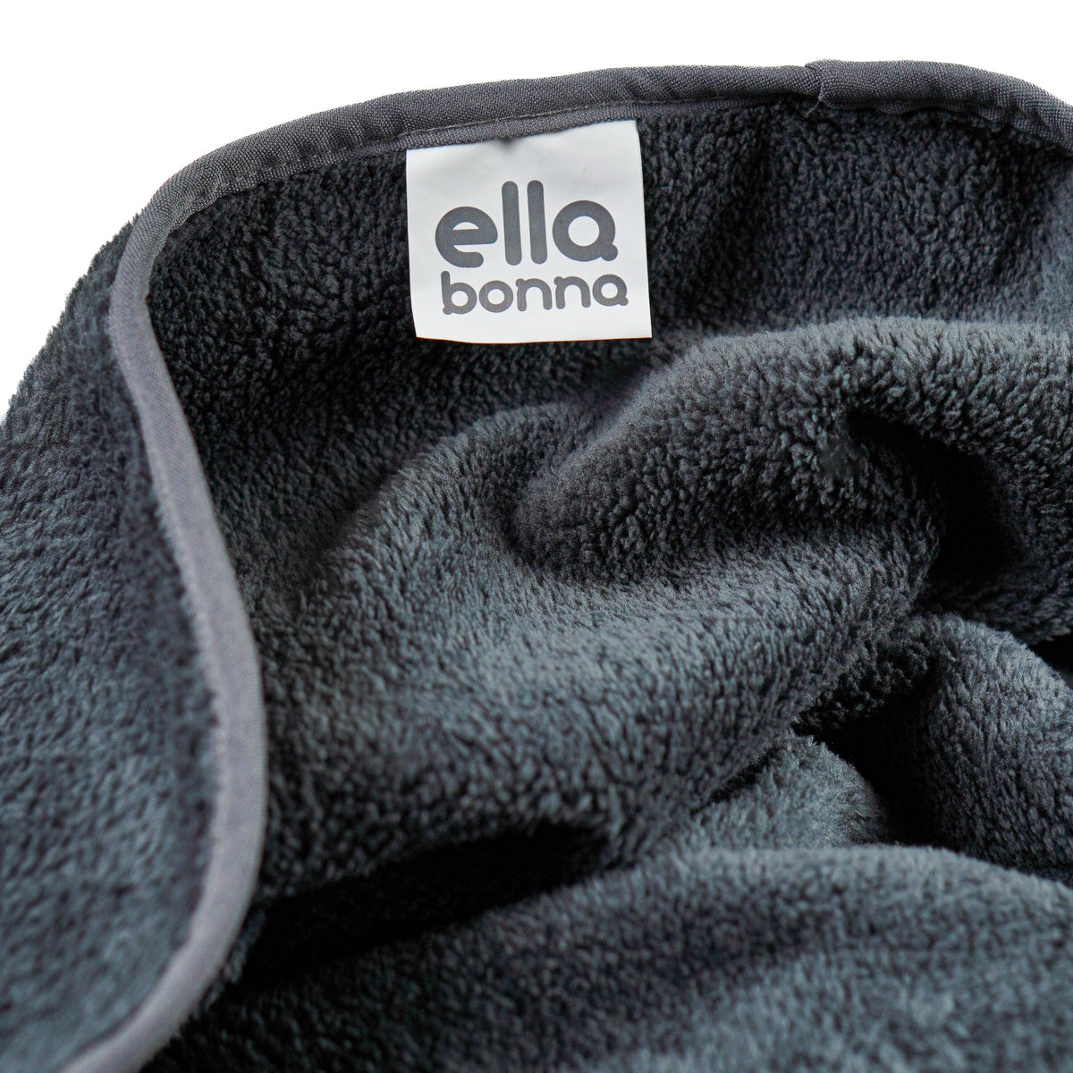 Charcoal fleece blanket edge and Ella Bonna label close-up.