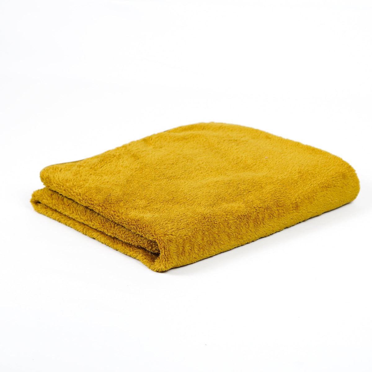 Mustard yellow fleece blanket folded on white.