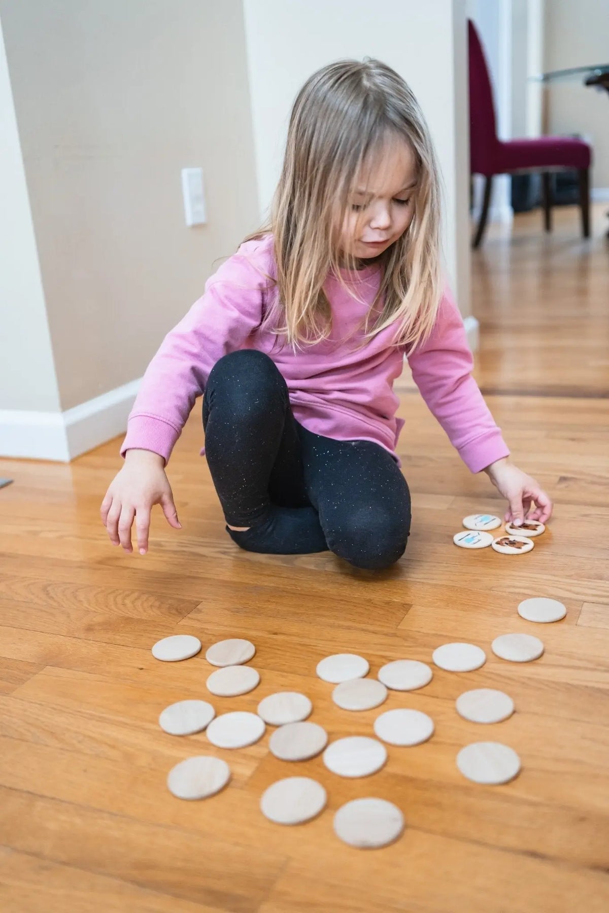 Lifestyle photo showing first responder matching tiles with a child
