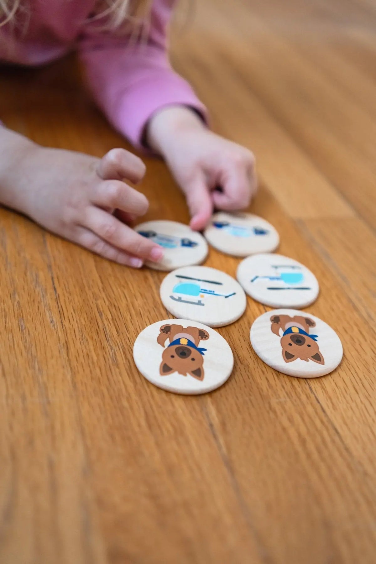 Lifestyle photo showing first responder matching tiles with a child