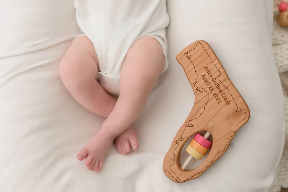 Lifestyle photo showing a wooden state rattle with a child