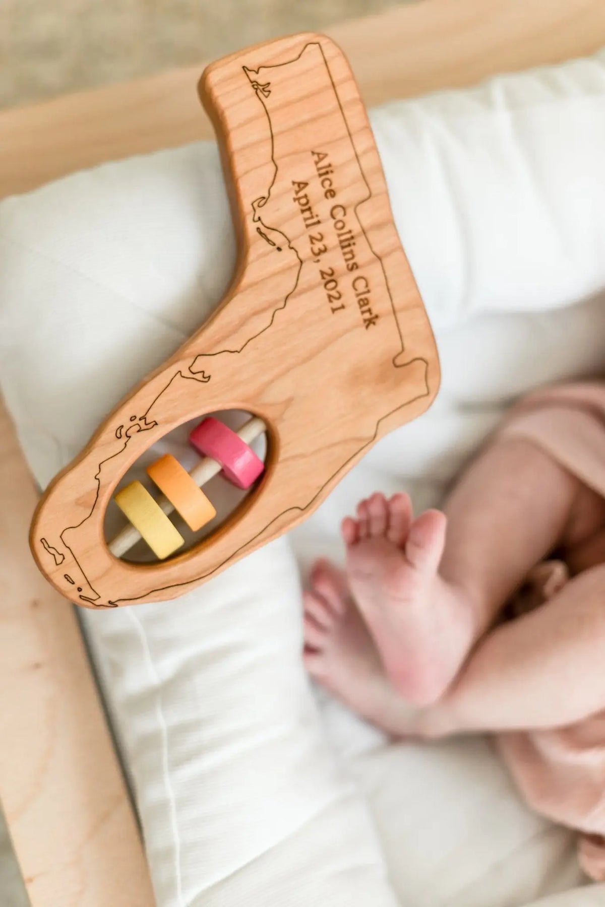 Bannor Toys Florida State Wooden Baby Rattle with example laser engraving and colored rattle discs