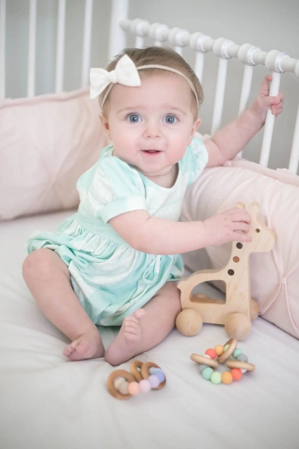 Lifestyle photo showing a wooden push toy with a child