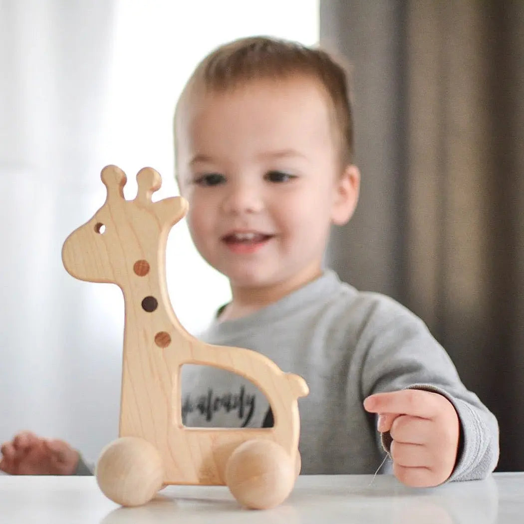 Lifestyle photo showing a wooden push toy with a child