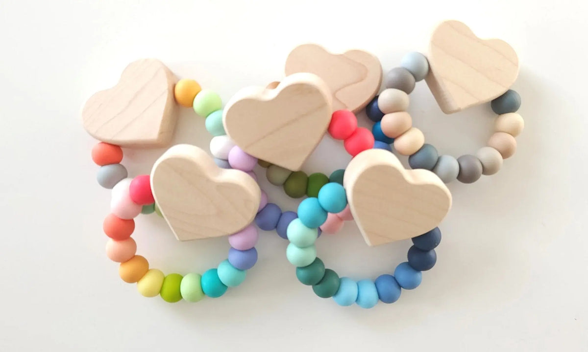 Bannor Toys Heart Charm Teether collection view, showing wooden component and colored silicone