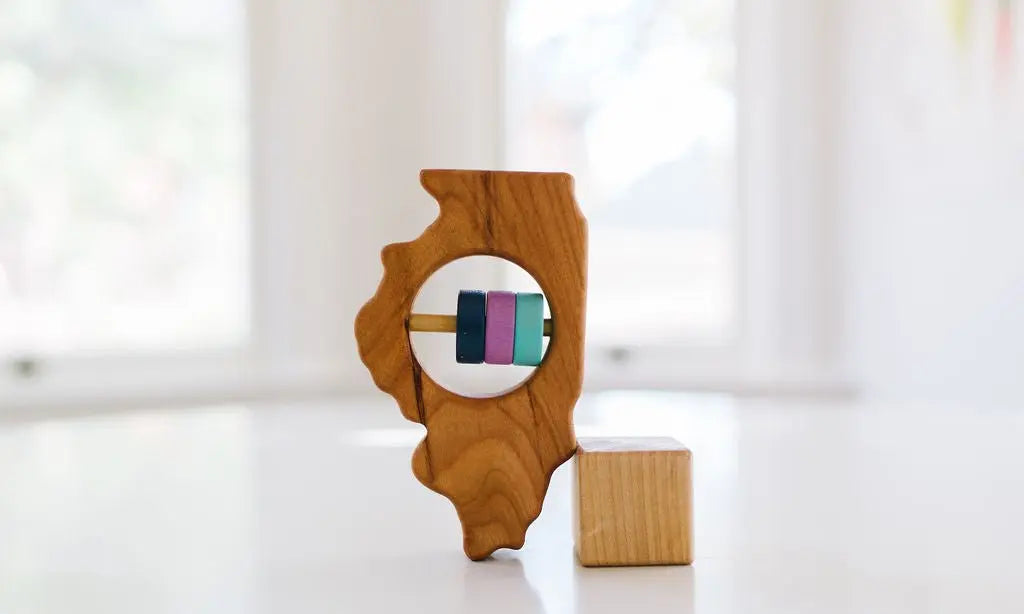 Bannor Toys Illinois State Wooden Baby Rattle, showing state-shaped cherry-wood body and colored rattle discs