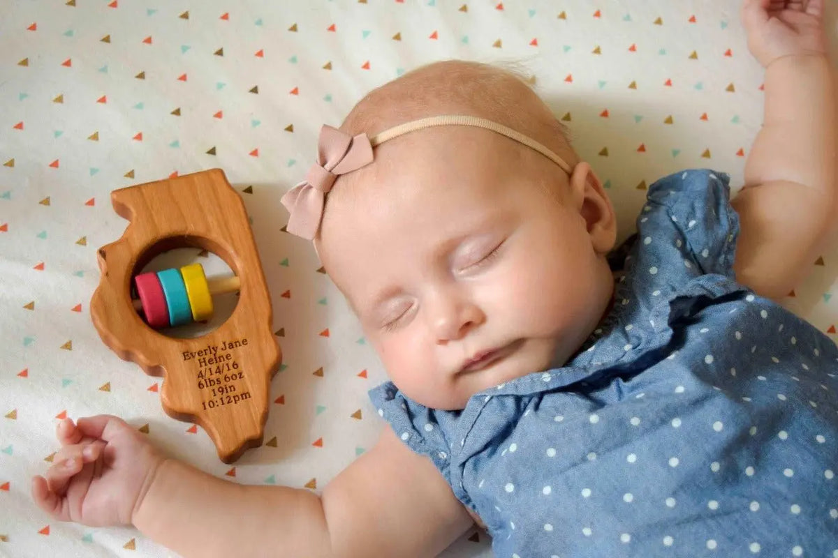 Lifestyle photo showing a wooden state rattle with a child
