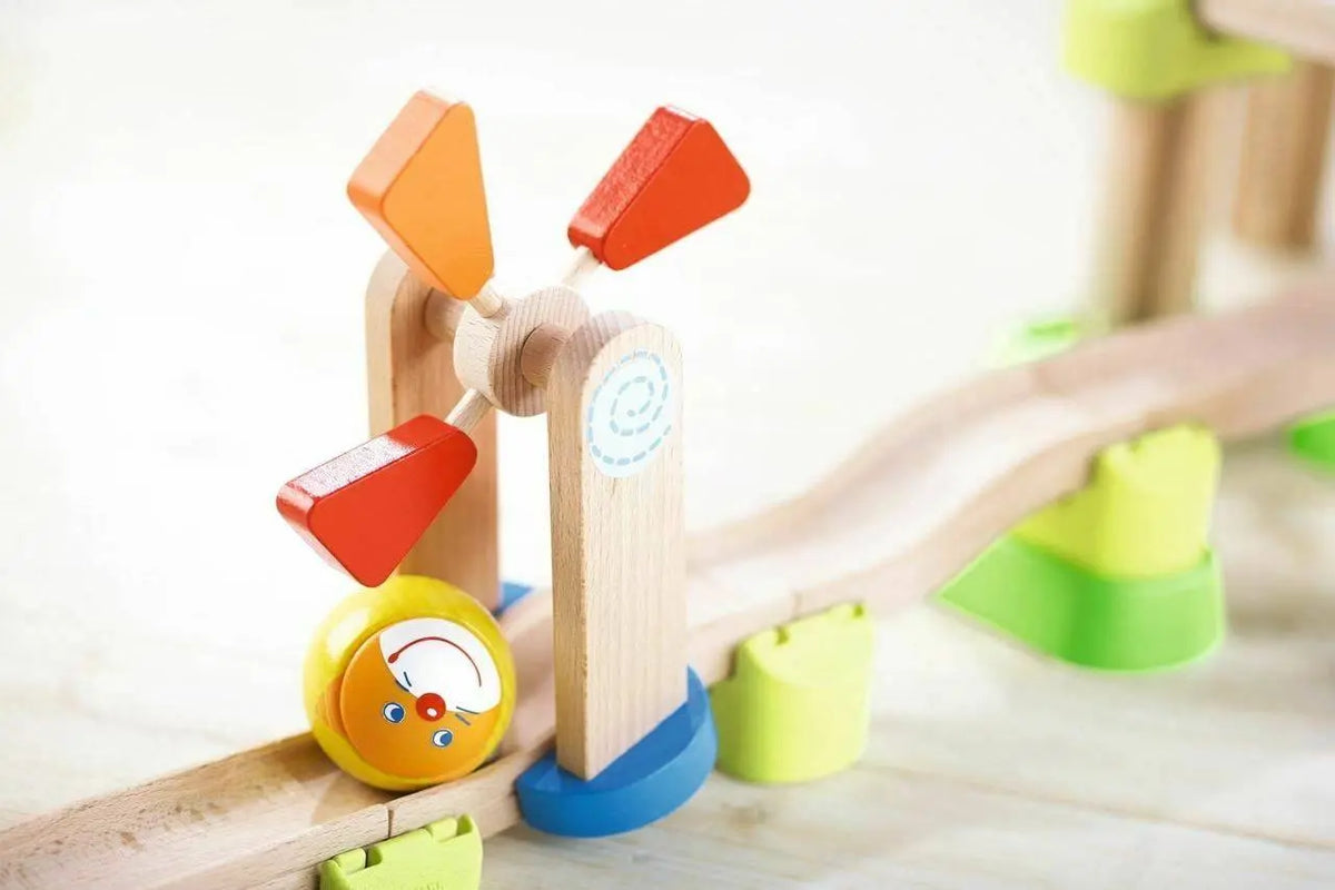 A yellow Kullerbu ball beside the windmill on the wooden track