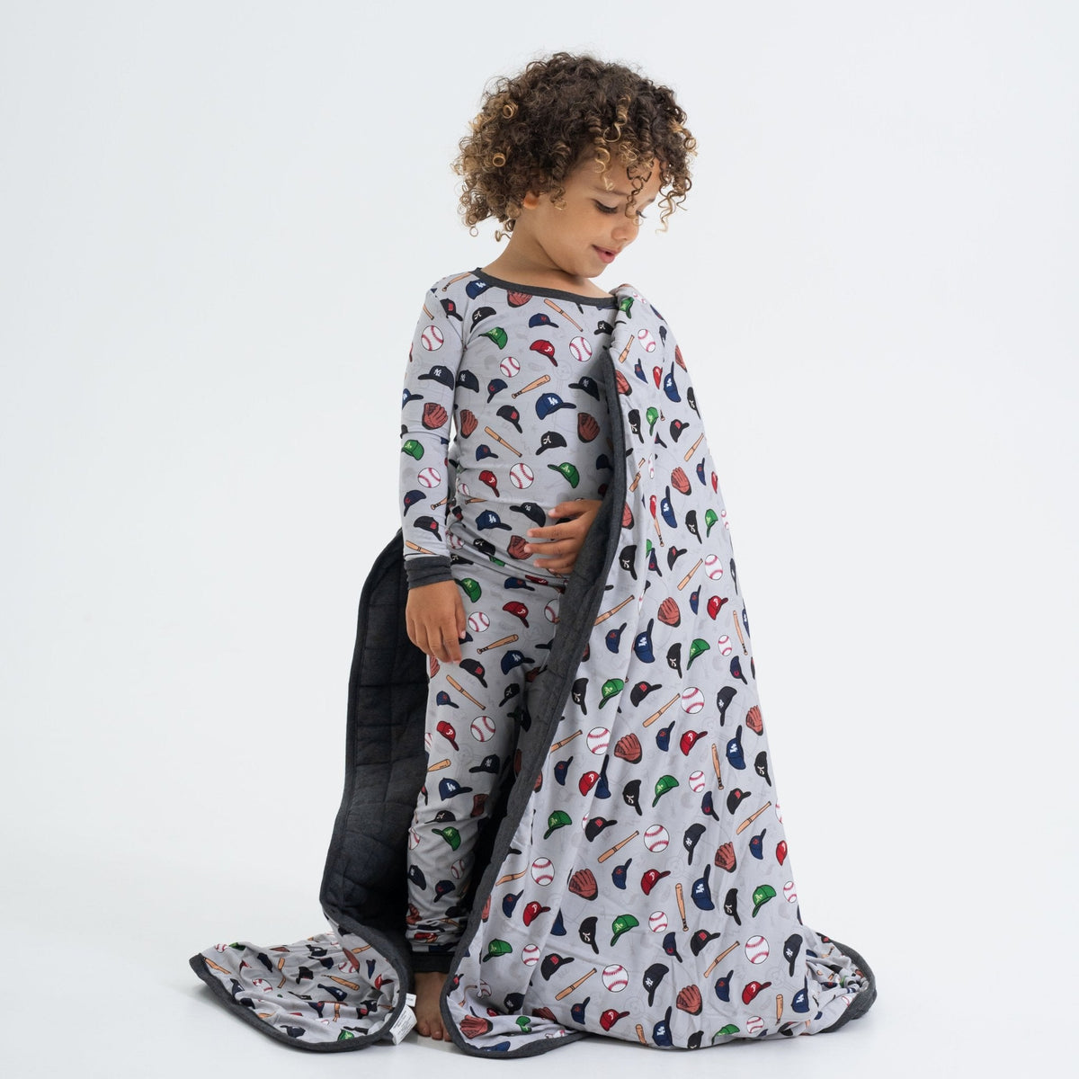 Child wrapped in Bam & Stitch Major League Buddies Blanket.