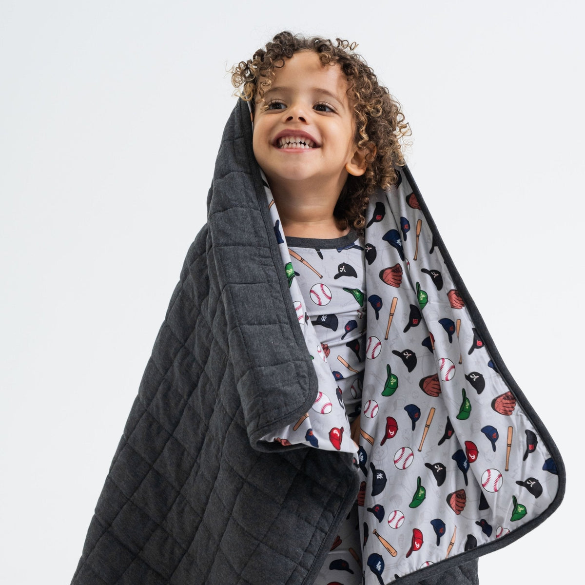 Child holding Bam & Stitch Major League Buddies Blanket over their head to show the reverse.