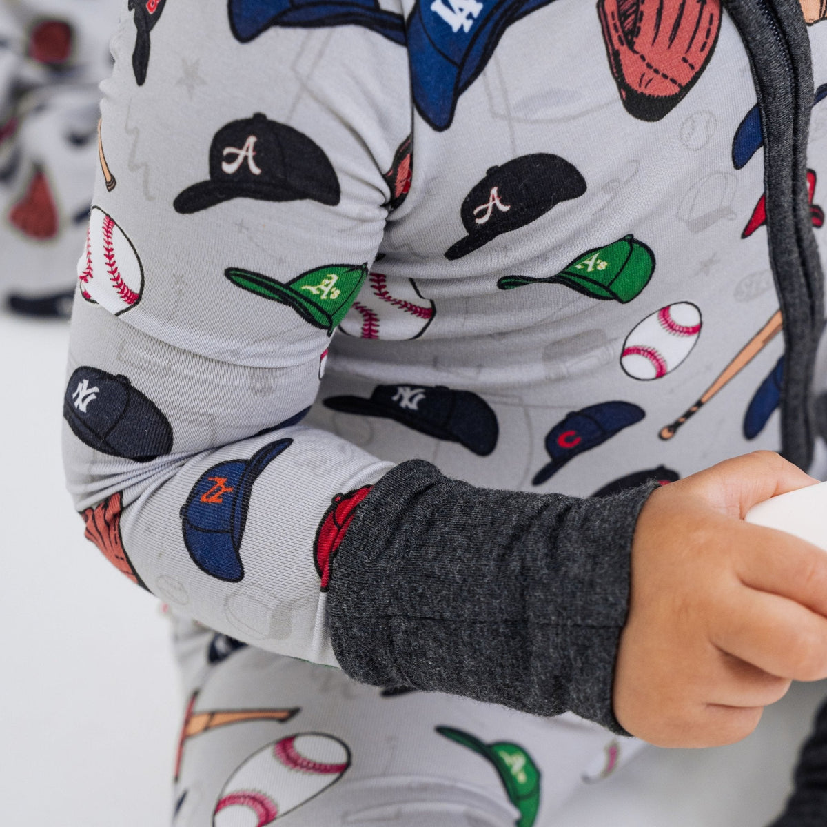 Close-up of the sleeve and cuff on Bam & Stitch Major League Buddies Convertible Romper.