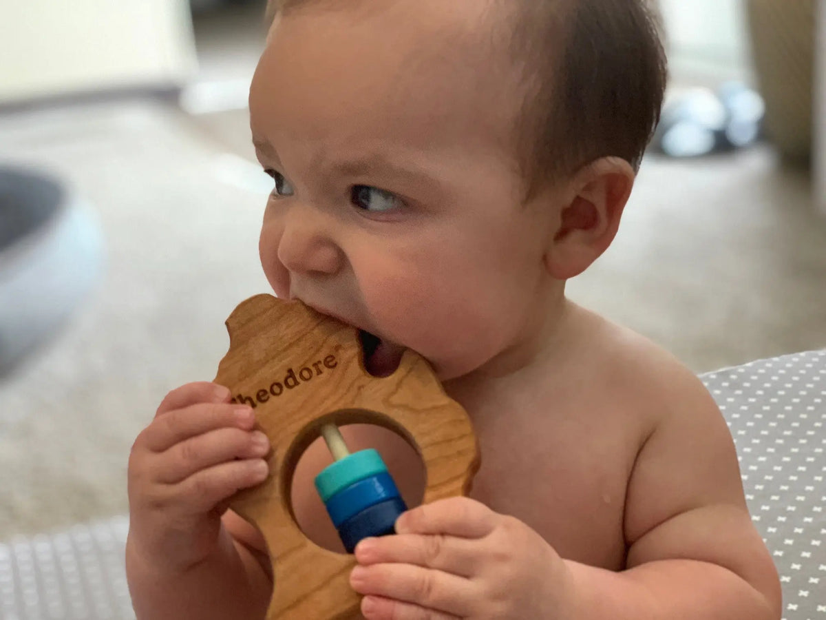 Lifestyle photo showing a wooden state rattle with a child