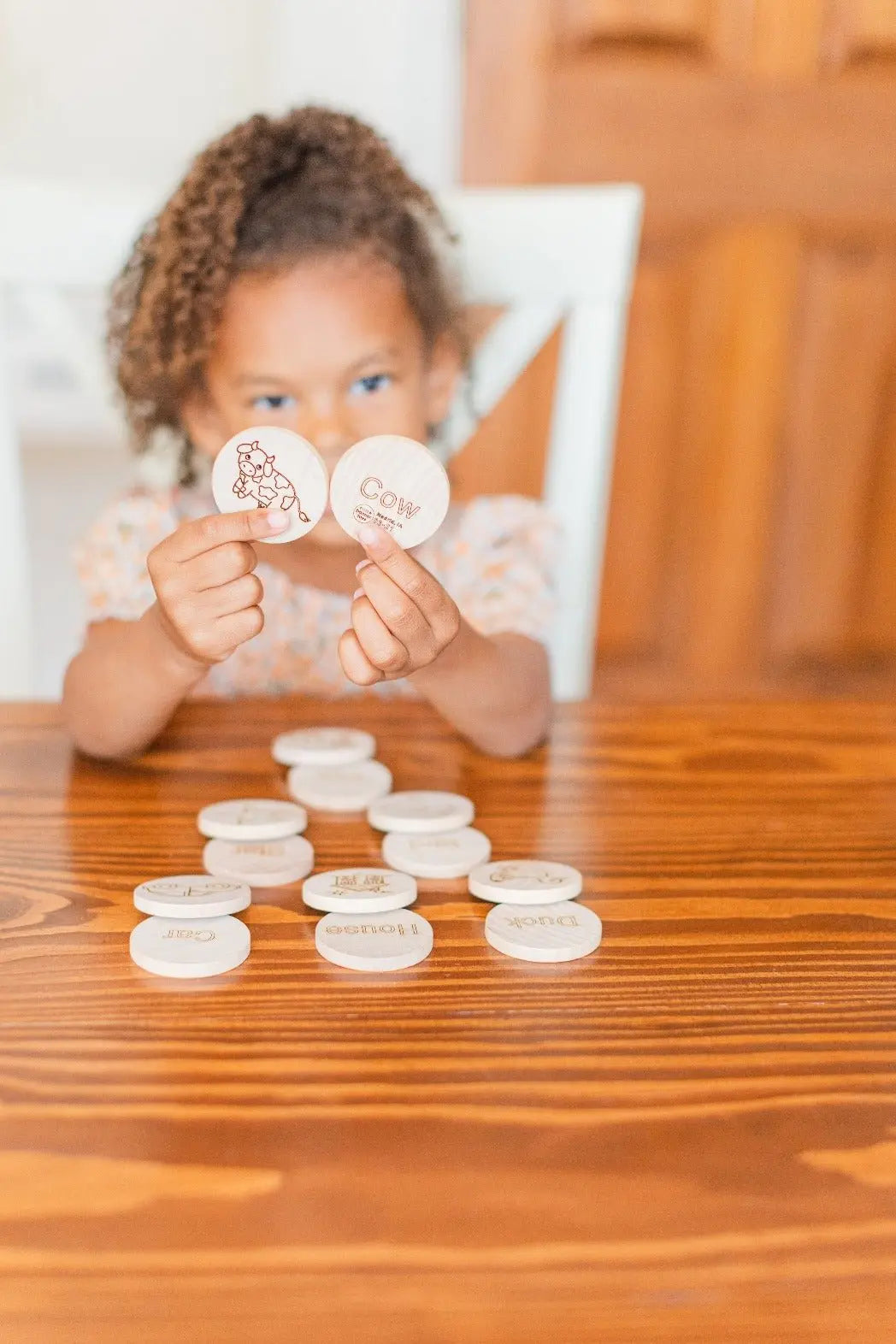 Lifestyle photo showing mini sight-word matching tiles with a child