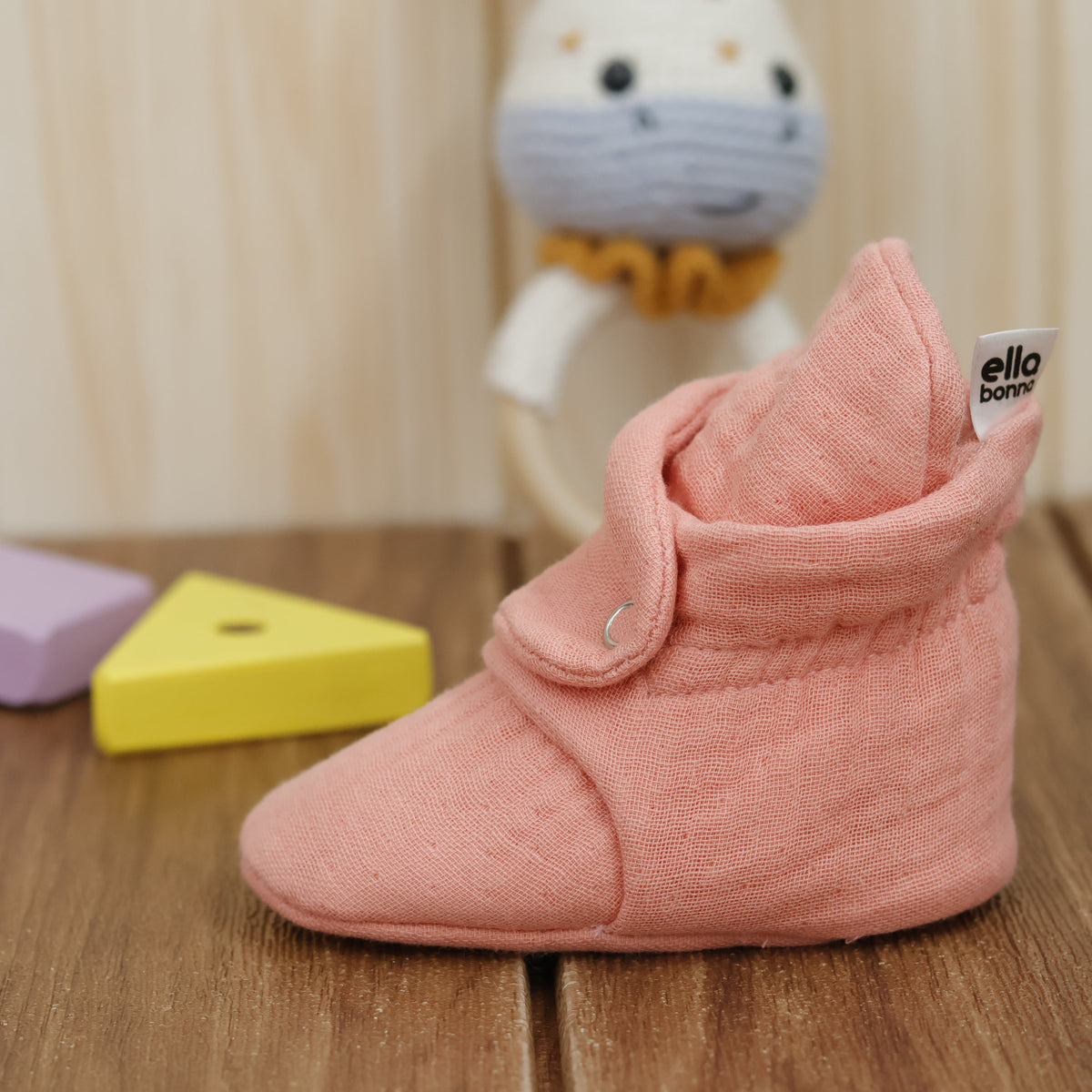 Single bootie on a tabletop, side view.