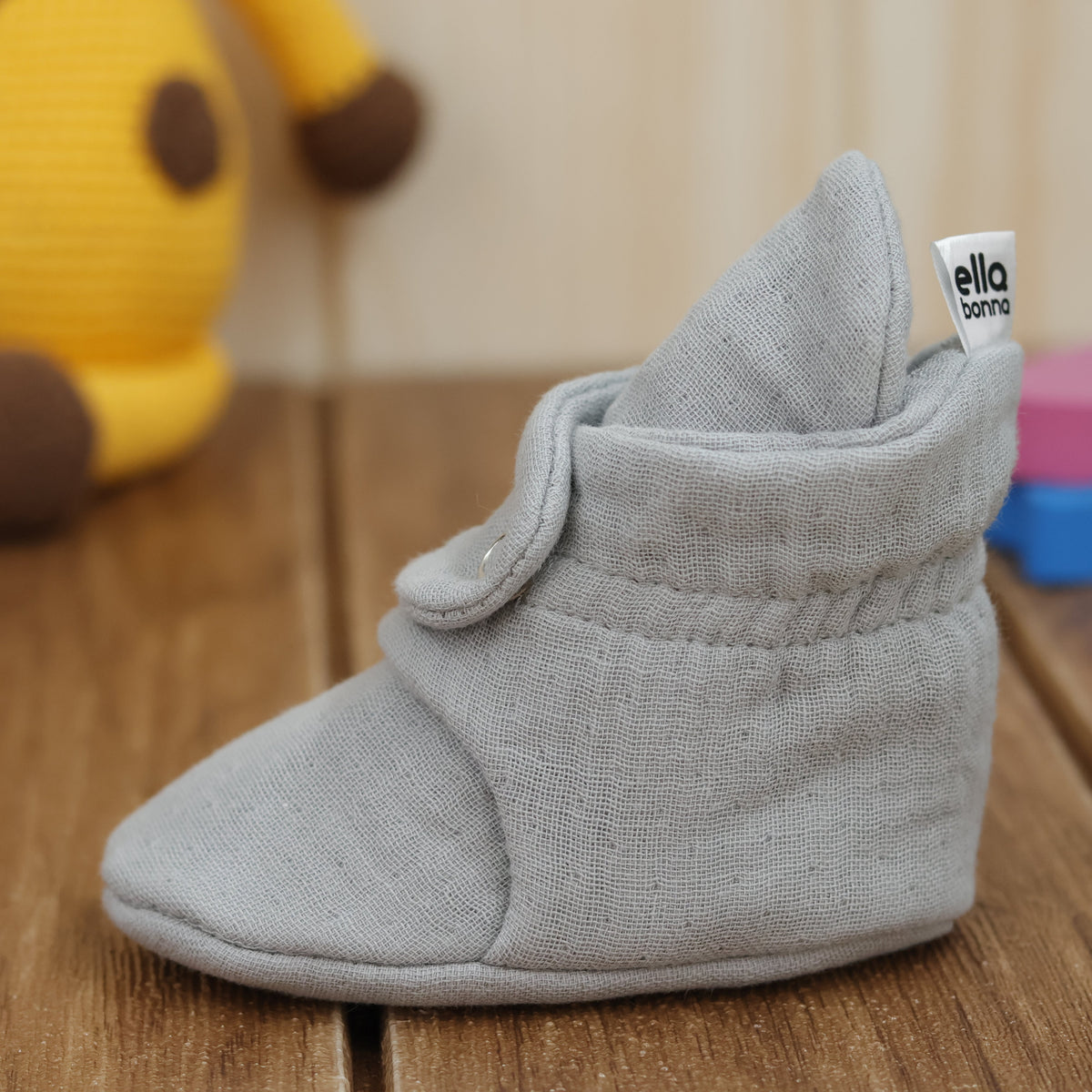 Single bootie on a tabletop, side view.