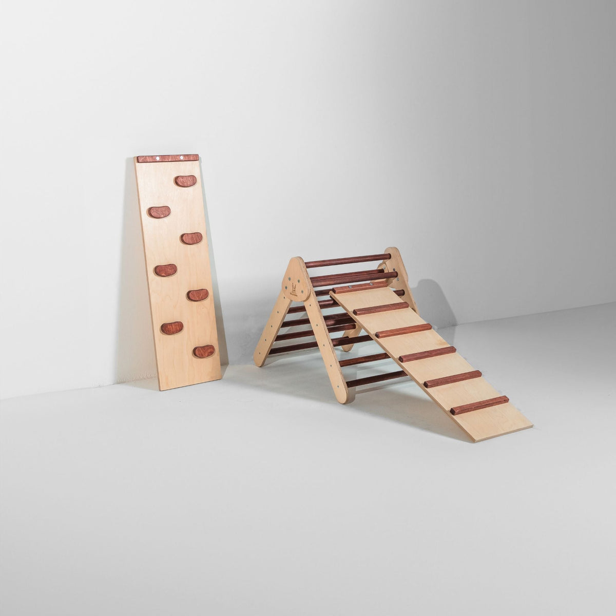 Small reddish-brown triangle with attached ladder ramp and a climbing-hold ramp beside it.