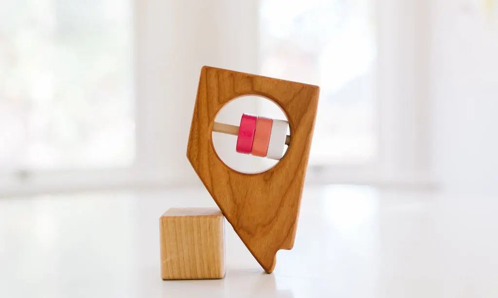 Bannor Toys Nevada State Wooden Baby Rattle, showing state-shaped cherry-wood body and colored rattle discs
