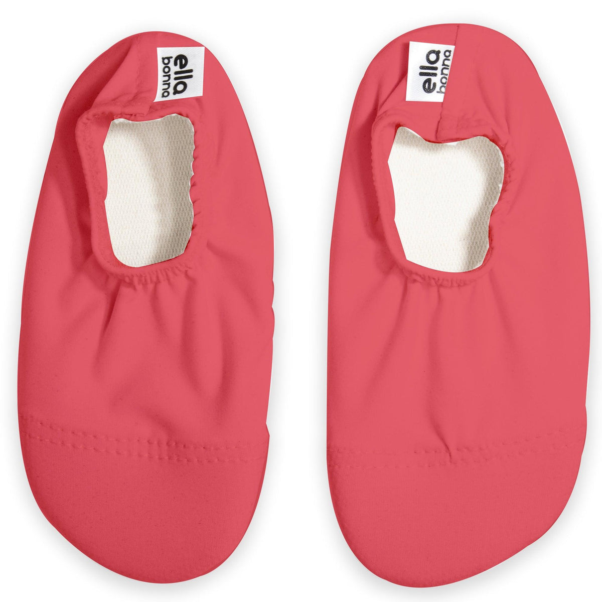 Top view of a pair of bright pink slip-on water shoes with cream lining on a white background.