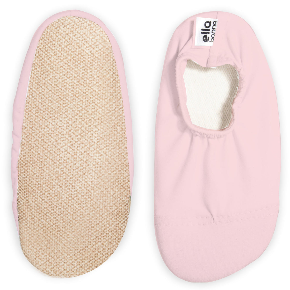 Pale pink slip-on water shoes with cream lining, with one sole facing the camera on a white background.