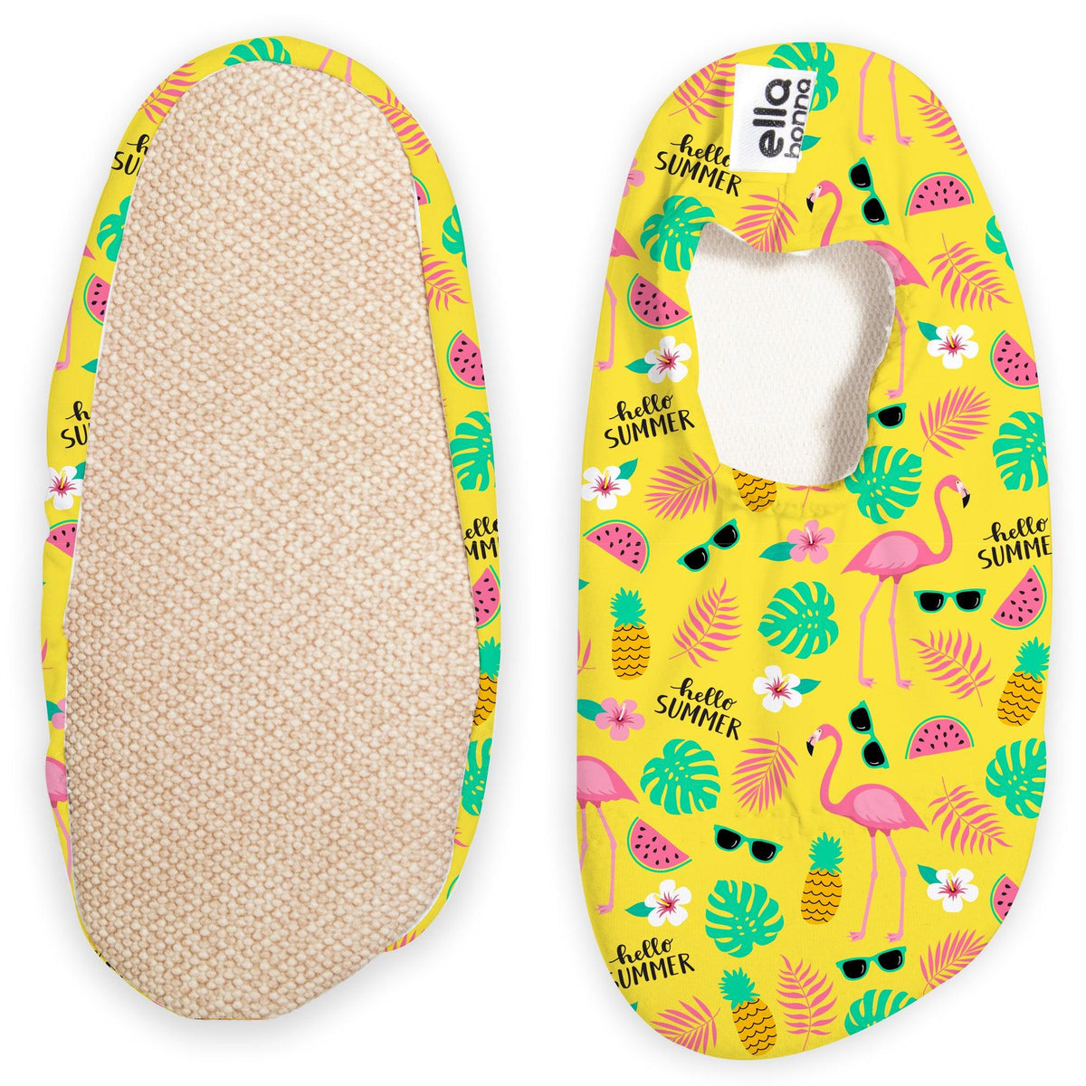 Yellow slip-on water shoes with pink flamingos, pineapples and green leaves, with one sole facing the camera on a white background.