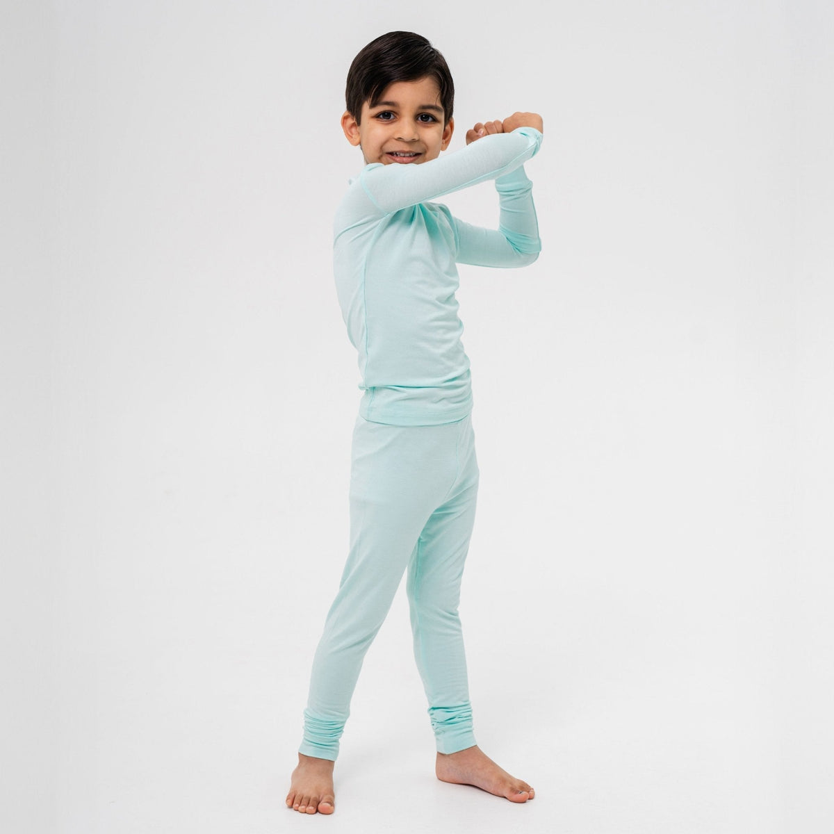 Child raising one elbow while wearing Bam & Stitch Ocean Breeze Long Sleeve Pajamas.