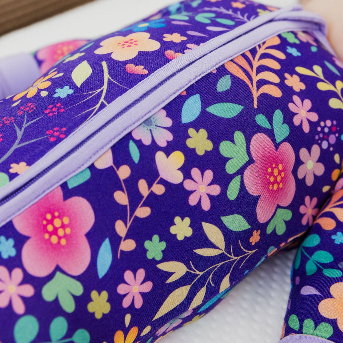 Close-up of the front zipper and fabric on Bam & Stitch Orchid Gardens Convertible Romper.