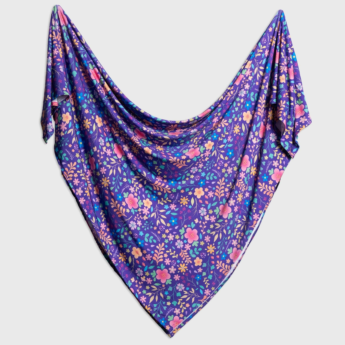 Bam & Stitch Orchid Gardens Swaddle draped open to show its color and pattern.