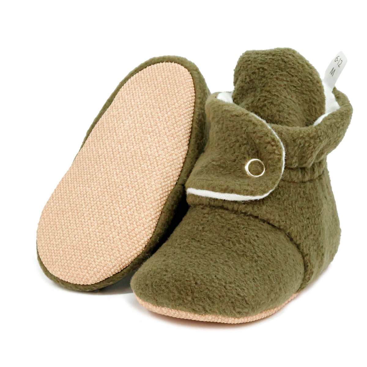 Olive green fleece-texture baby booties with snap straps and tan soles, with one sole facing the camera on a white background.