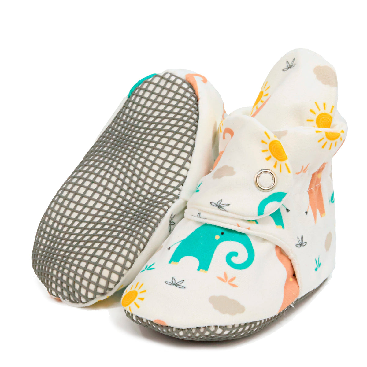 Cream baby booties with pastel elephant print and snap straps, with one sole facing the camera on a white background.