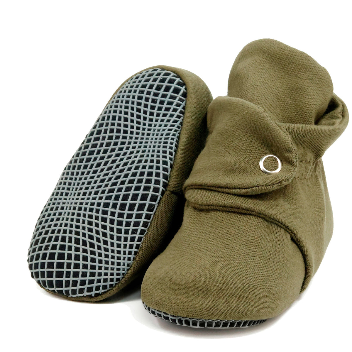 Olive green fabric baby booties with snap straps and gray grip soles, with one sole facing the camera on a white background.