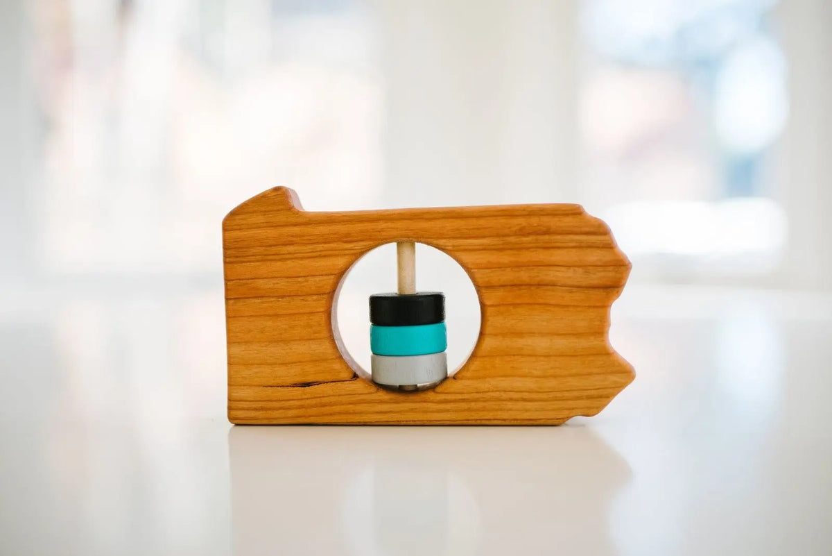 Bannor Toys Pennsylvania State Wooden Baby Rattle, showing state-shaped cherry-wood body and colored rattle discs