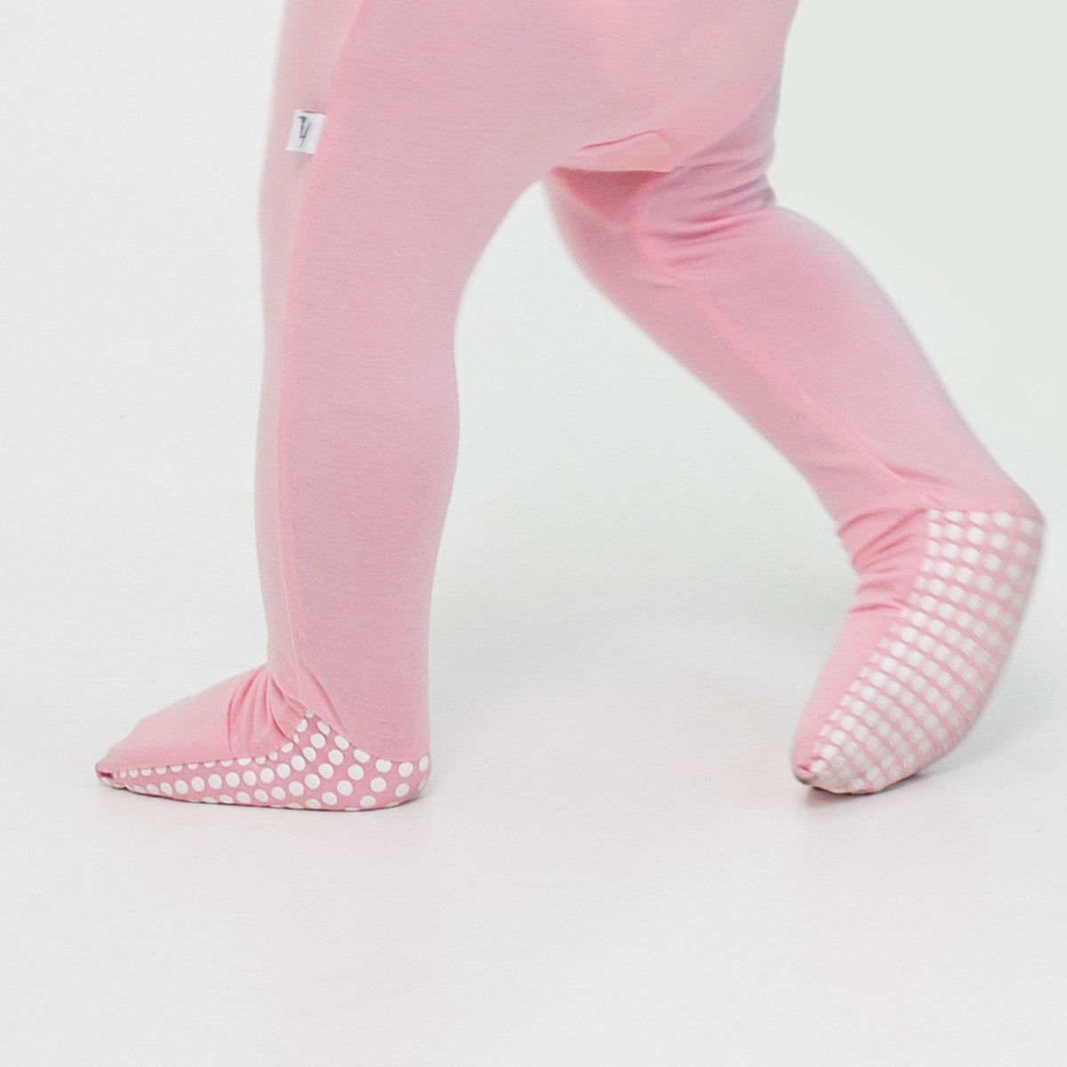 Close-up of the fold-over feet and dotted soles on Bam & Stitch Pink Blossom Convertible Romper.