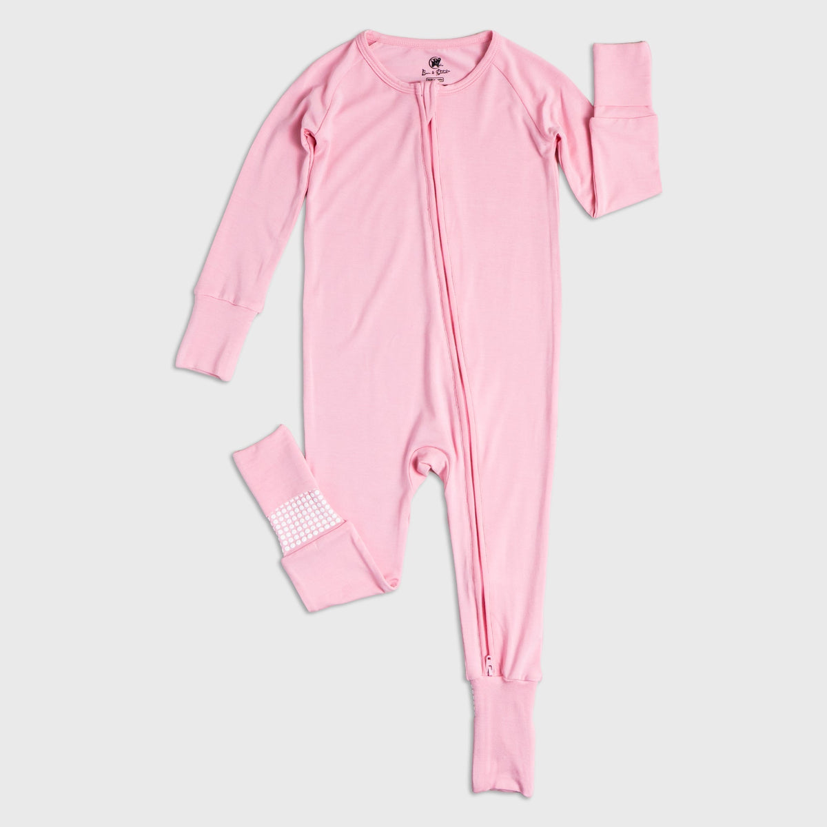 Flat lay of Bam & Stitch Pink Blossom Convertible Romper, showing the complete garment.