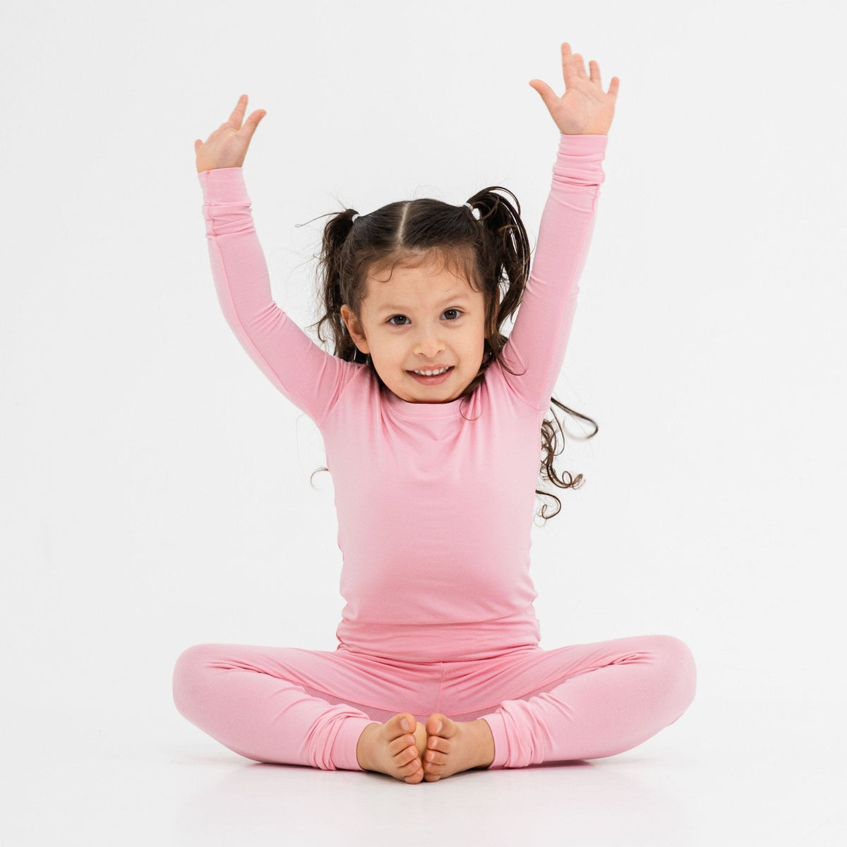 Child seated in Bam & Stitch Pink Blossom Long Sleeve Pajamas.