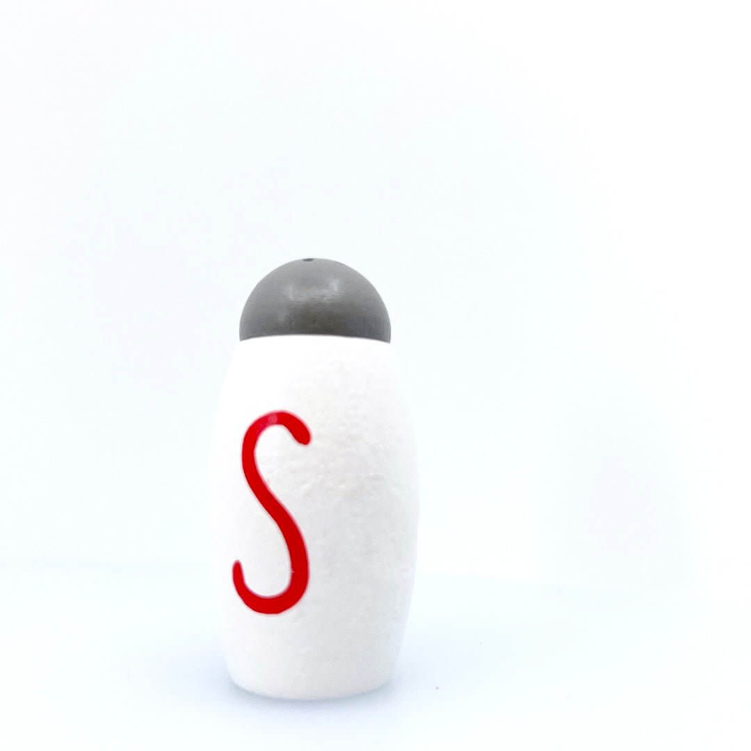White toy salt shaker with a red S and gray top