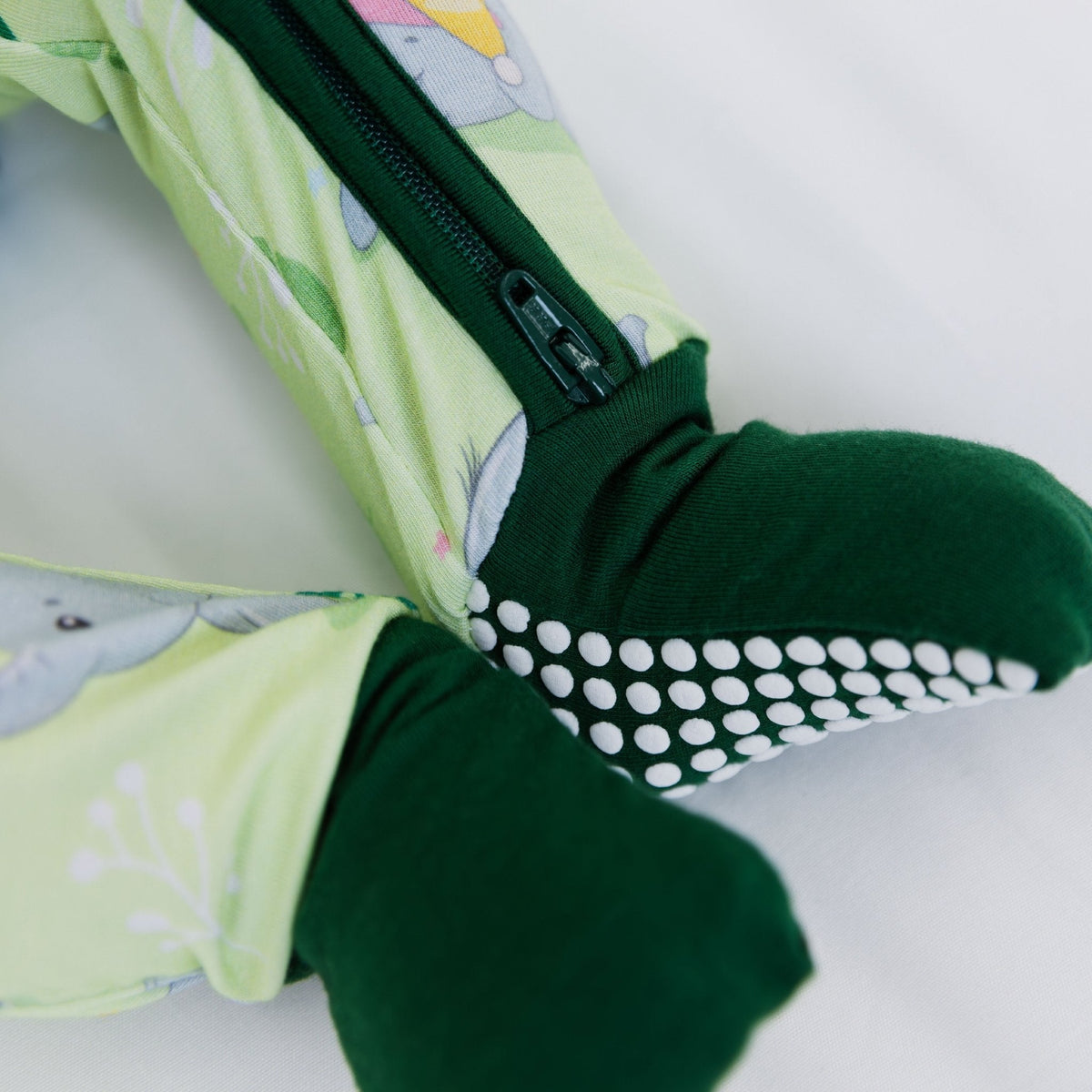 Close-up of the fold-over feet and dotted soles on Bam & Stitch Playfully Strong Convertible Romper.