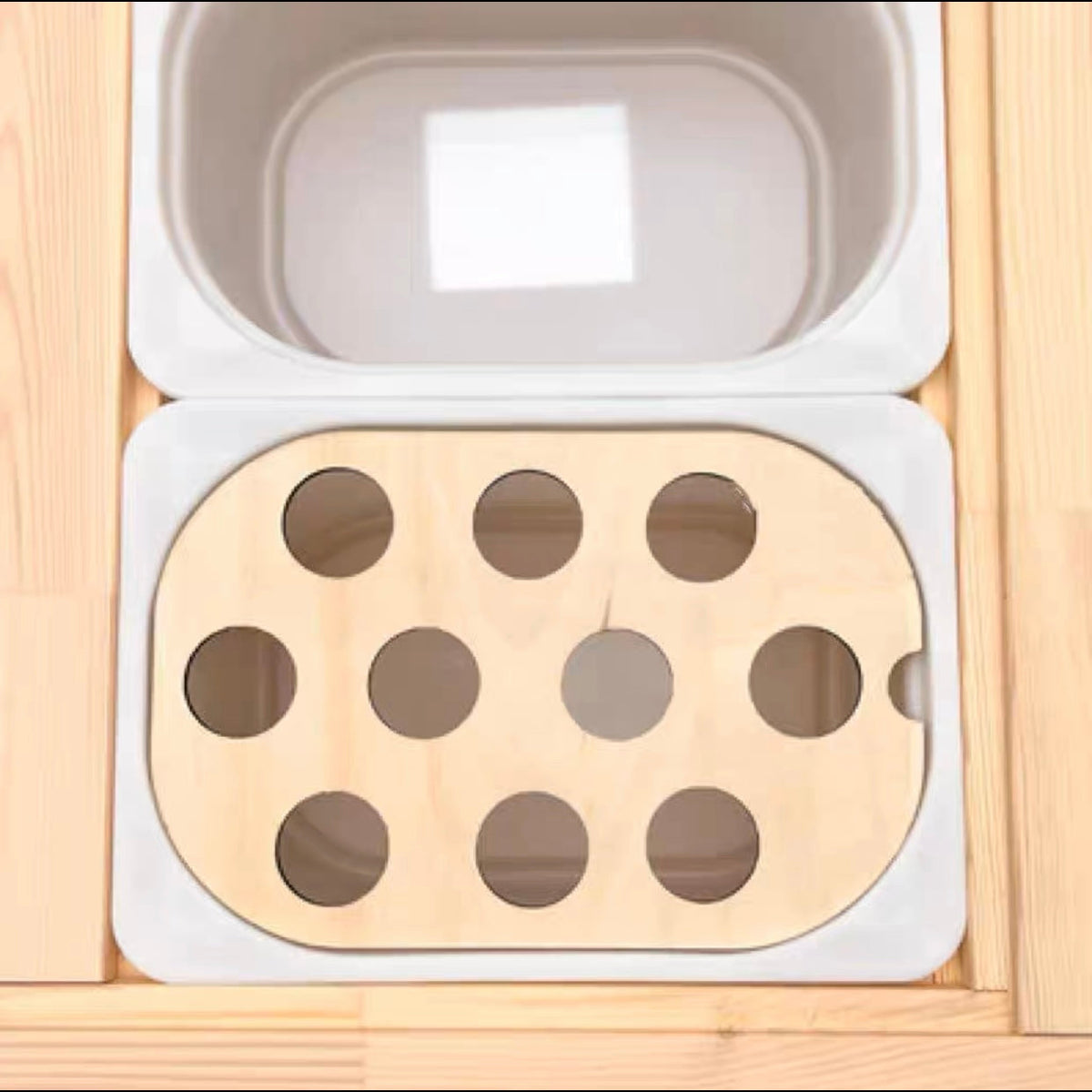 Wooden 10-hole sensory bin insert fitted in a table bin