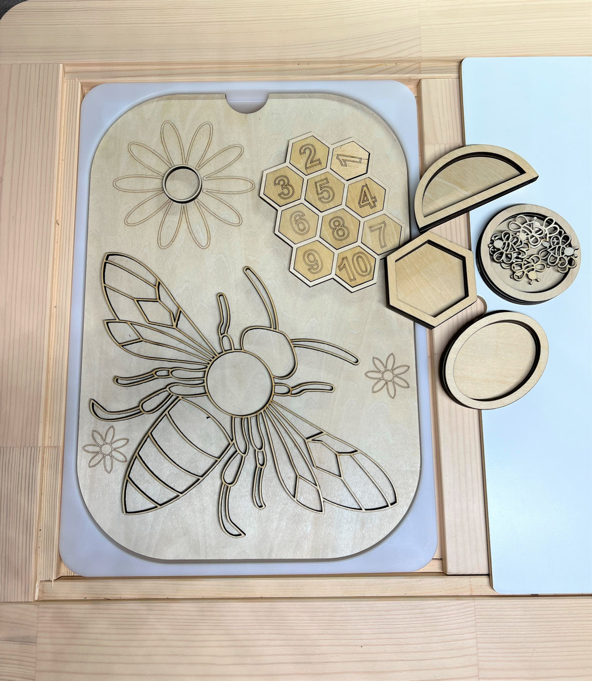 Bee activity board with removable honeycomb pieces